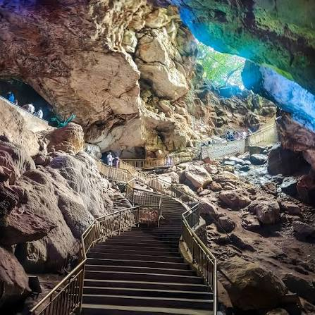 Stone stairs descending into Borra Caves, with railings and limestone chambers